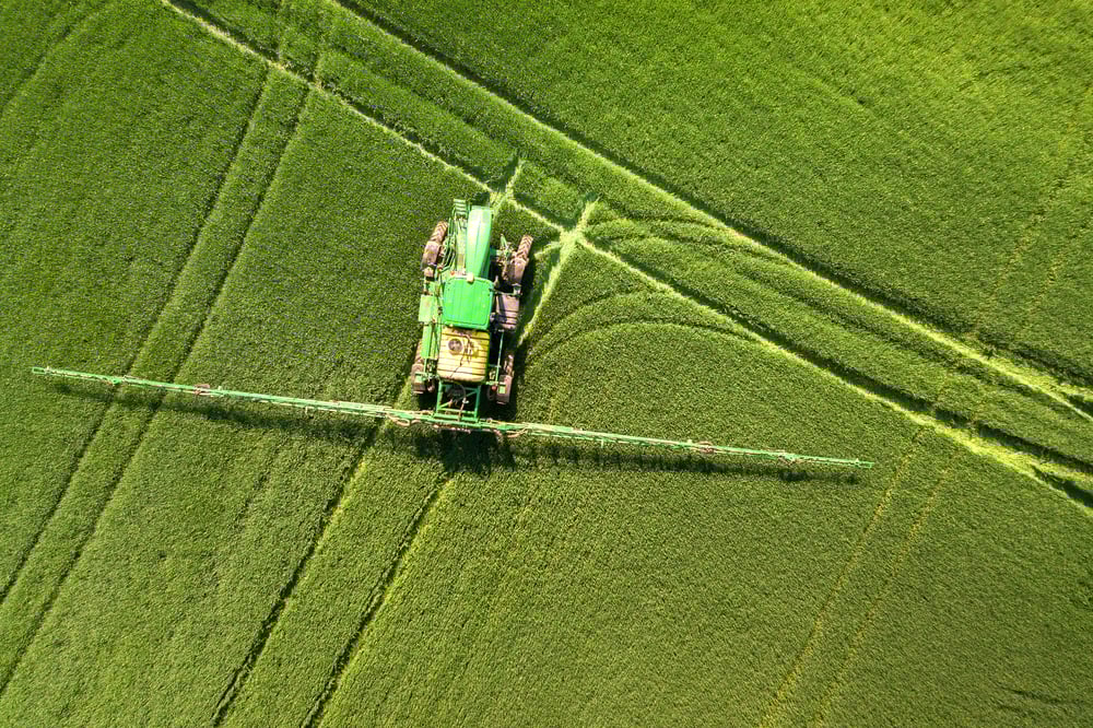 tractor-spraying-chemical-pesticides-with-sprayer-2022-01-12-06-33-19-utc